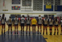 The HRV Girls' Volleyball Team stands for the national anthem